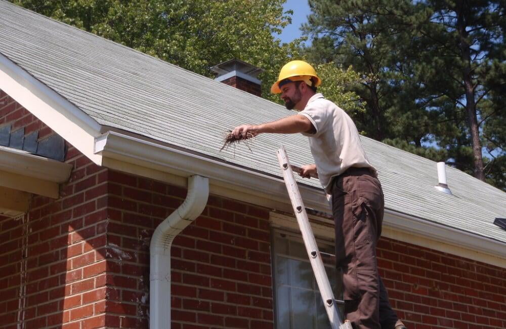 Gutter cleaning with ladder and hose